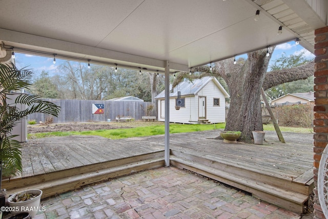 wooden terrace featuring an outbuilding