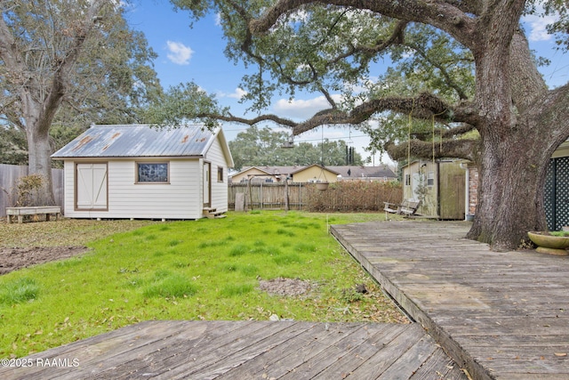 view of yard featuring a deck and a shed