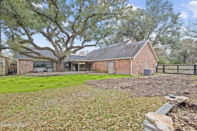 back of house with a yard and central air condition unit