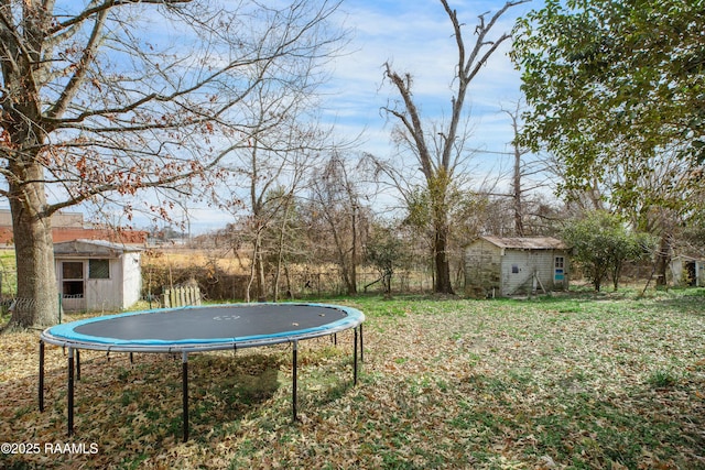 view of yard with a storage shed and a trampoline