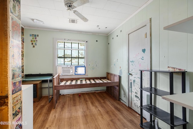 miscellaneous room with cooling unit, ornamental molding, light hardwood / wood-style floors, and ceiling fan