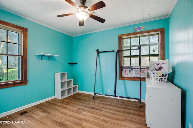 miscellaneous room with hardwood / wood-style flooring, ceiling fan, ornamental molding, and cooling unit