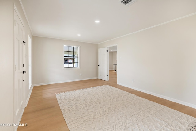 unfurnished bedroom featuring crown molding and hardwood / wood-style floors