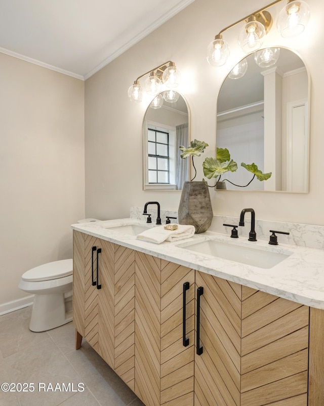 bathroom with crown molding, vanity, tile patterned floors, and toilet