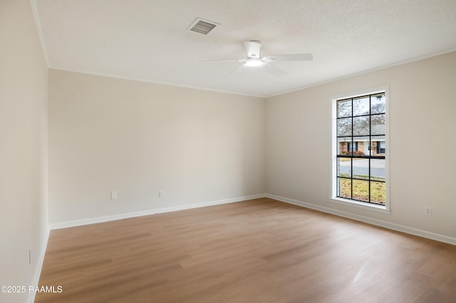 unfurnished room featuring ceiling fan, crown molding, light hardwood / wood-style flooring, and a textured ceiling