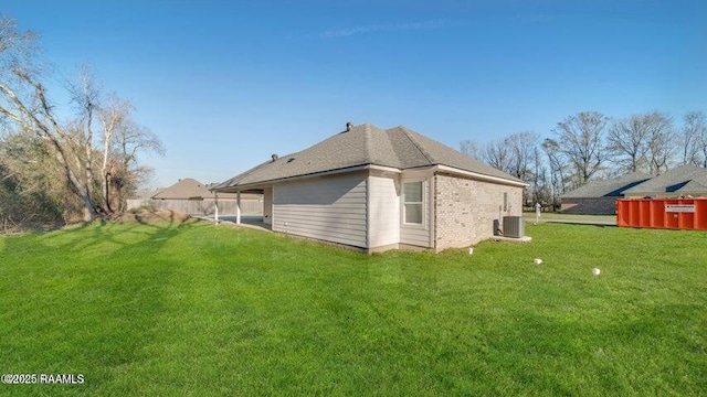 exterior space featuring a lawn and central air condition unit