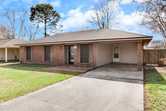 single story home with a front yard and a carport