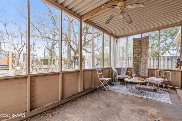 unfurnished sunroom featuring a ceiling fan