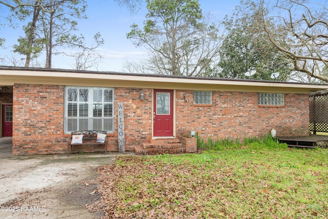 ranch-style home with brick siding and entry steps