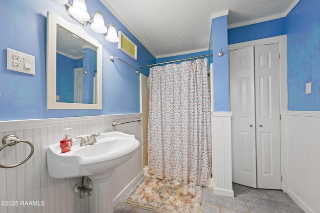 bathroom featuring visible vents, tile patterned flooring, a shower stall, wainscoting, and a closet