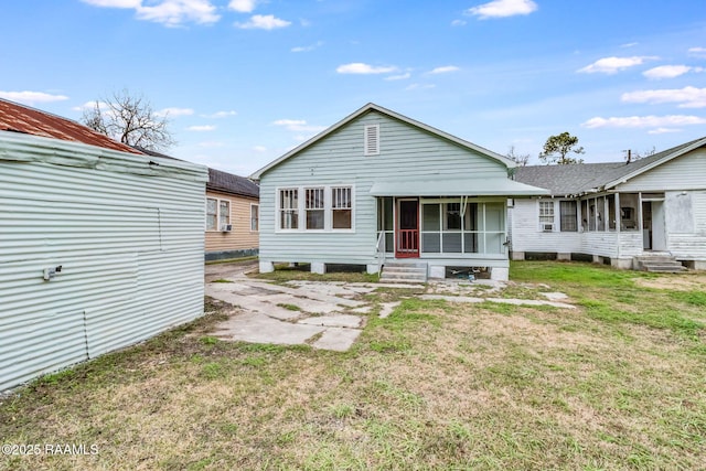 rear view of property featuring a yard