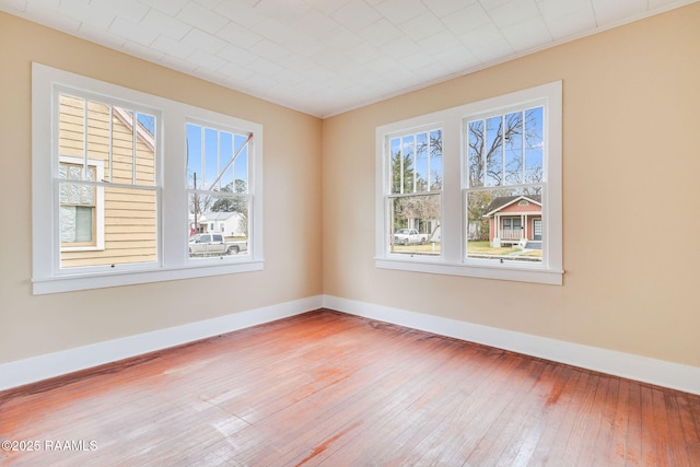 spare room with hardwood / wood-style flooring