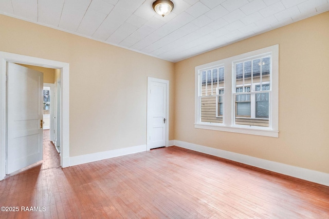 spare room with wood-type flooring