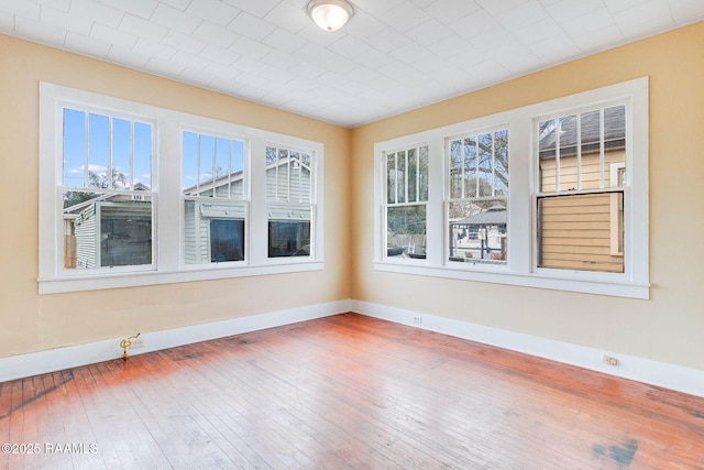 unfurnished room with hardwood / wood-style flooring