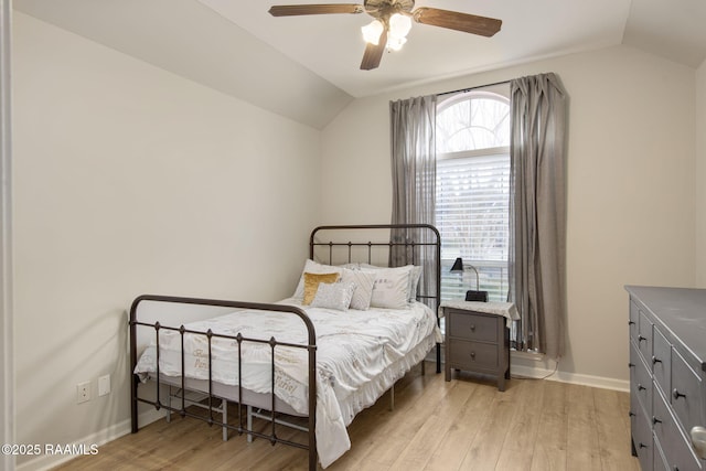 bedroom featuring vaulted ceiling, light wood-style flooring, baseboards, and ceiling fan