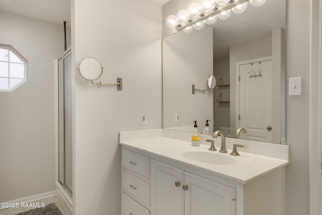 bathroom featuring a stall shower and vanity