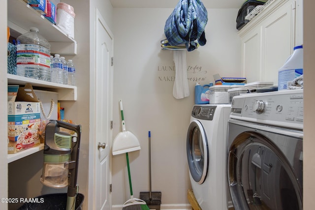 clothes washing area featuring separate washer and dryer and cabinet space