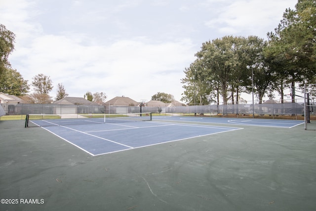 view of sport court featuring fence