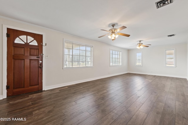 entryway featuring crown molding, plenty of natural light, dark hardwood / wood-style floors, and ceiling fan