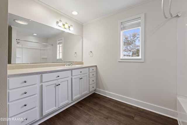 bathroom featuring crown molding, vanity, and hardwood / wood-style floors