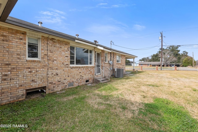 exterior space featuring a lawn and central air condition unit