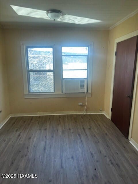 empty room with dark hardwood / wood-style flooring, cooling unit, and ornamental molding