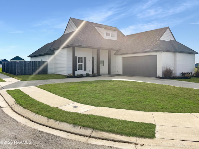 view of front facade with fence, a shingled roof, a garage, concrete driveway, and a front lawn