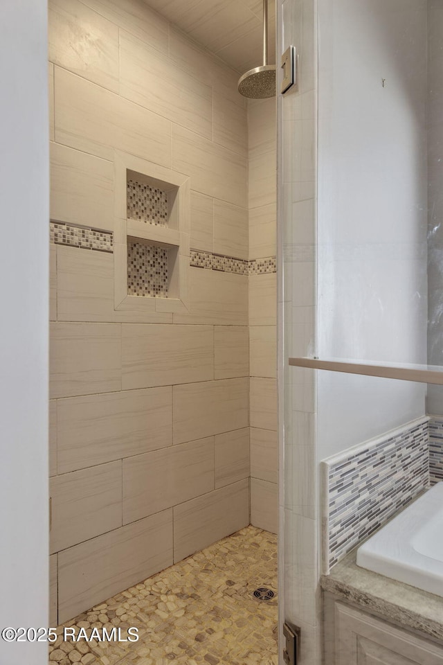 bathroom with tiled shower