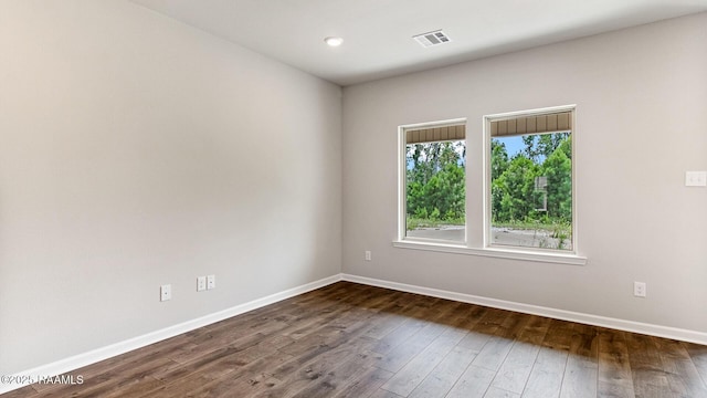 spare room with dark hardwood / wood-style flooring