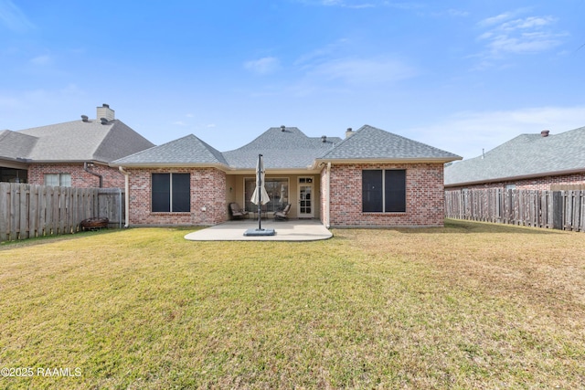 back of house featuring a patio and a yard