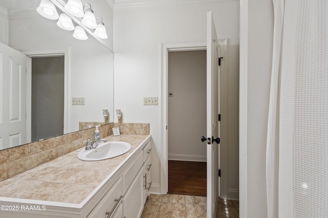 bathroom featuring vanity, ornamental molding, and tile patterned floors