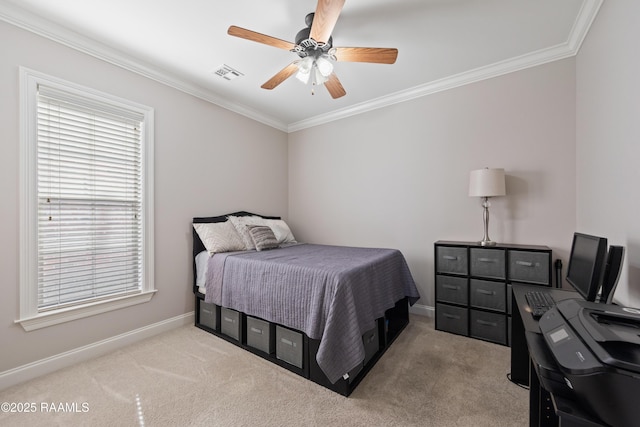 carpeted bedroom with ceiling fan and ornamental molding