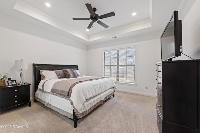 carpeted bedroom with ceiling fan, ornamental molding, and a raised ceiling