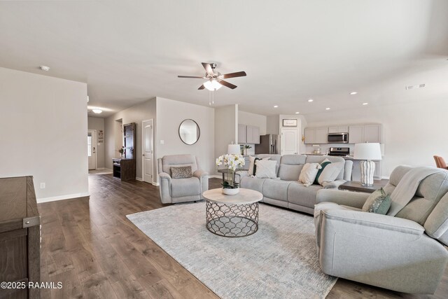 living room featuring ceiling fan, recessed lighting, wood finished floors, and baseboards