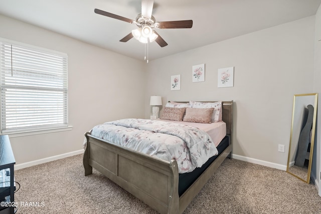 carpeted bedroom with baseboards and a ceiling fan