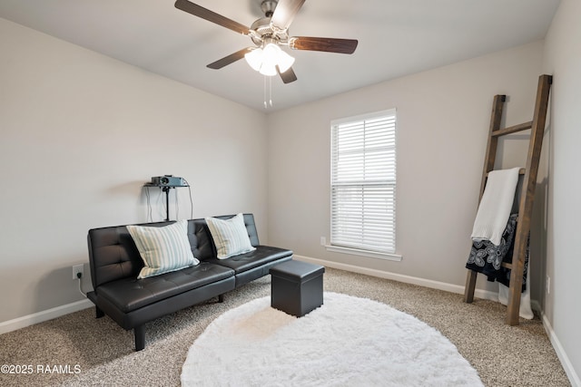 sitting room with ceiling fan, carpet floors, and baseboards