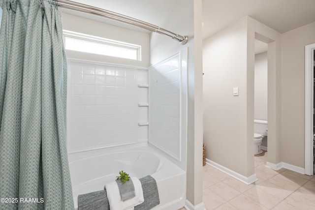 bathroom featuring shower / bath combination with curtain, tile patterned flooring, baseboards, and toilet