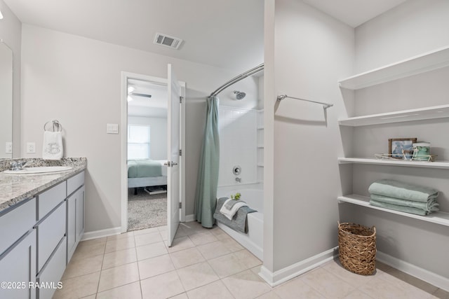 ensuite bathroom with visible vents, shower / bath combo with shower curtain, vanity, tile patterned flooring, and baseboards