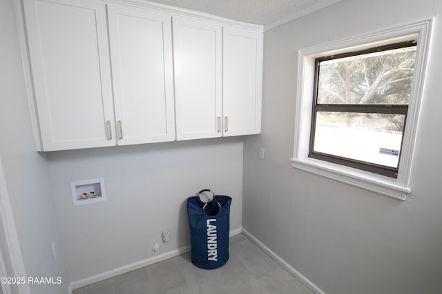 laundry area featuring washer hookup, cabinets, a textured ceiling, and gas dryer hookup