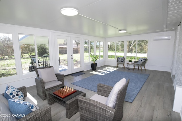 sunroom featuring vaulted ceiling and a wall mounted air conditioner