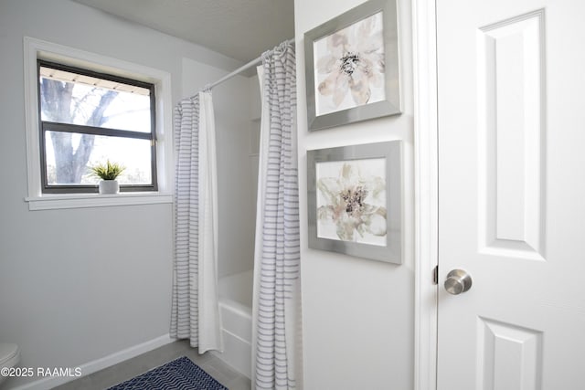 bathroom with shower / tub combo with curtain, a textured ceiling, and toilet