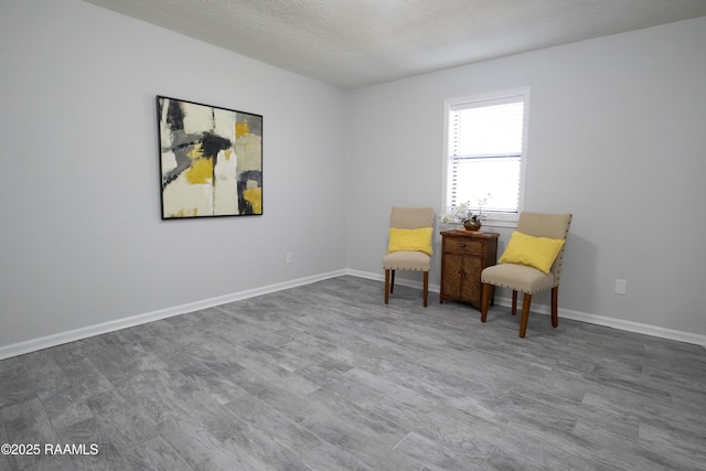 living area featuring hardwood / wood-style flooring and a textured ceiling