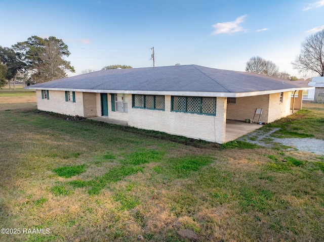 single story home with a front yard and a carport