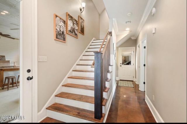 stairway featuring ornamental molding, concrete floors, and ceiling fan