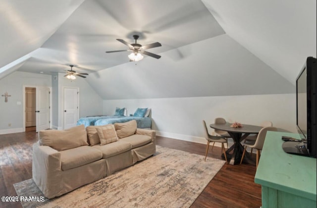 living room with ceiling fan, dark hardwood / wood-style floors, and vaulted ceiling