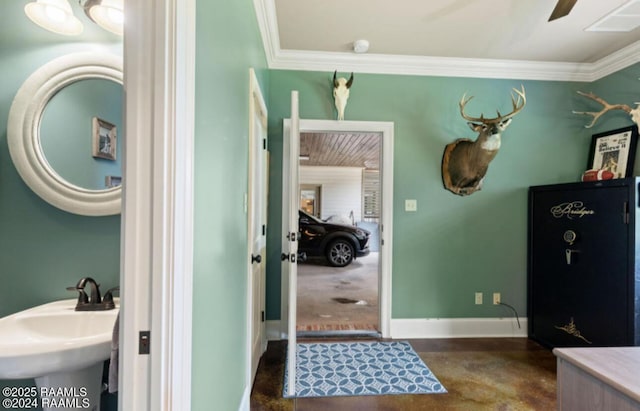 bathroom with a ceiling fan, crown molding, baseboards, and a sink