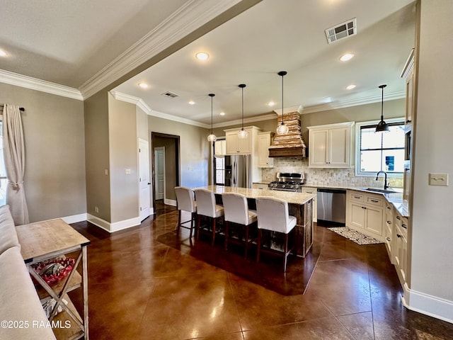 kitchen featuring custom exhaust hood, visible vents, stainless steel appliances, and a sink