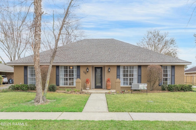 ranch-style home featuring a front yard