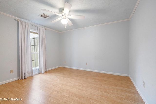 spare room with ceiling fan, ornamental molding, light hardwood / wood-style floors, and a textured ceiling