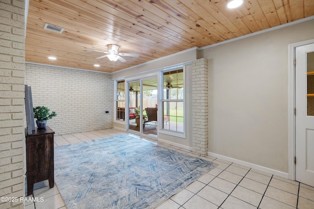 interior space featuring brick wall, wooden ceiling, and ceiling fan